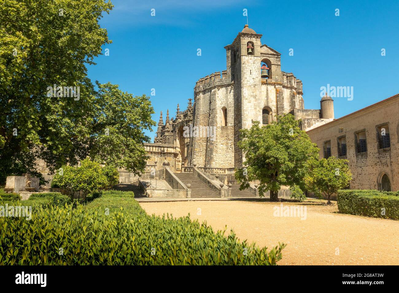 Tomar, Portugal - June 3, 2021: Exterior view of the Convento de Cristo church in Tomar, Portugal, with access path to the convent, through the garden Stock Photo