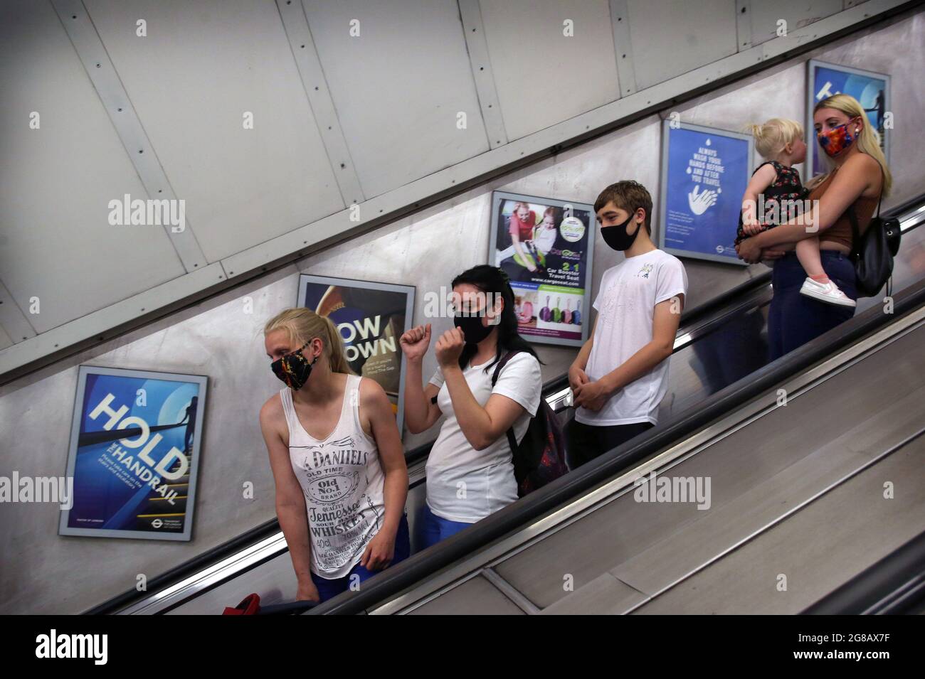 London, UK. 8th Aug, 2020. Passengers wearing face coverings use the escalator at Kings Cross, during the covid 19 restrictions period.After more than a year of restrictions for travellers' mandatory face mask wearing and social distancing will end (on Monday 19th July). The government has still advised the wearing of face masks and allowing extra space in crowded spaces indoors. (Credit Image: © Martin Pope/SOPA Images via ZUMA Press Wire) Stock Photo