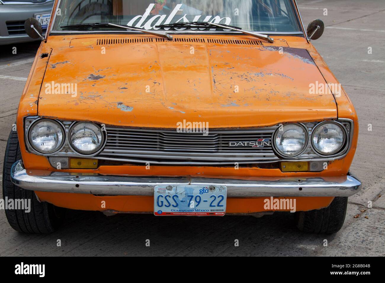 The front of a very old Datsun car still running in the streets of Mexico. Stock Photo