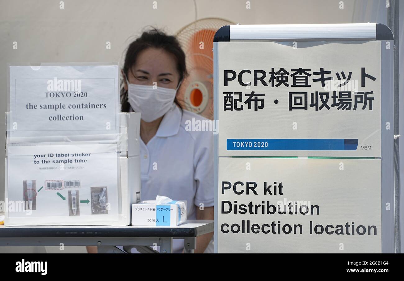Tokio, Japan. 19th July, 2021. A woman stands at the collection point for the saliva samples from the Corona PCR test. The 2020 Tokyo Olympic Games will be held from 23.07.2021 to 08.08.2021. Credit: Michael Kappeler/dpa/Alamy Live News Stock Photo