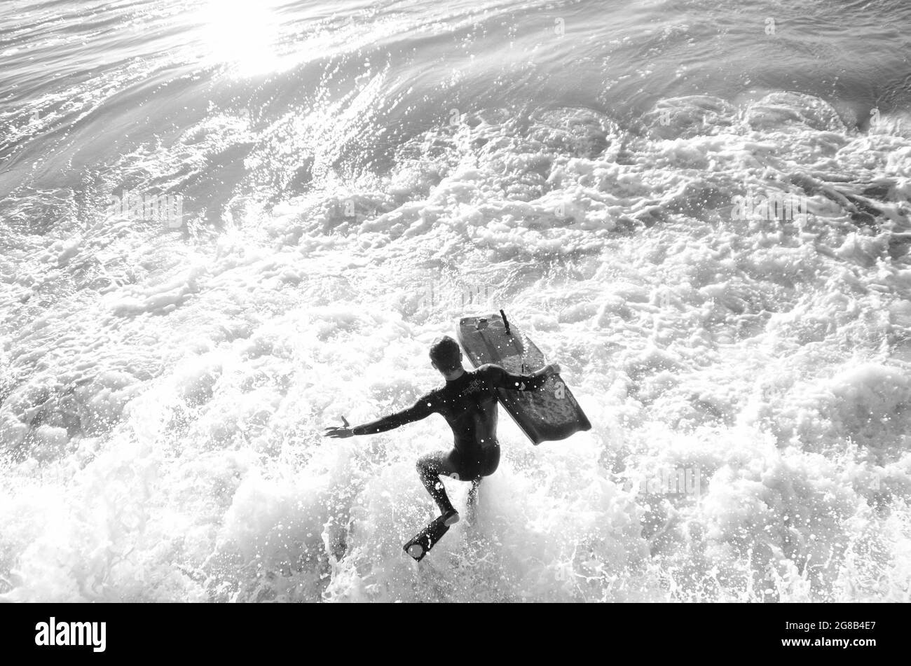 Bodyboarder Jumps Into Breaking Waves. Santa Barbara, California Stock Photo