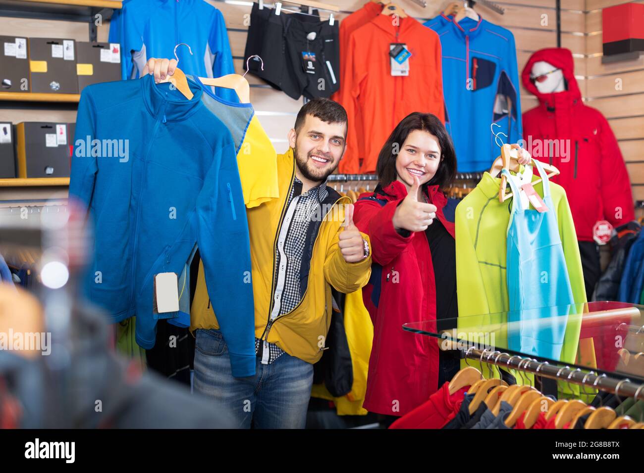 Couple demonstrating sportswear in store Stock Photo