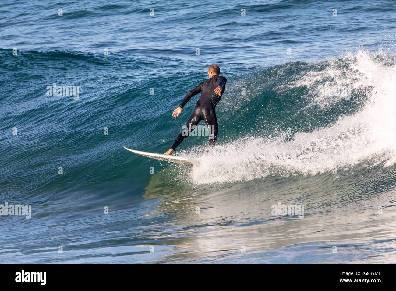 Surfer in wetsuit ride on hi-res stock photography and images - Alamy