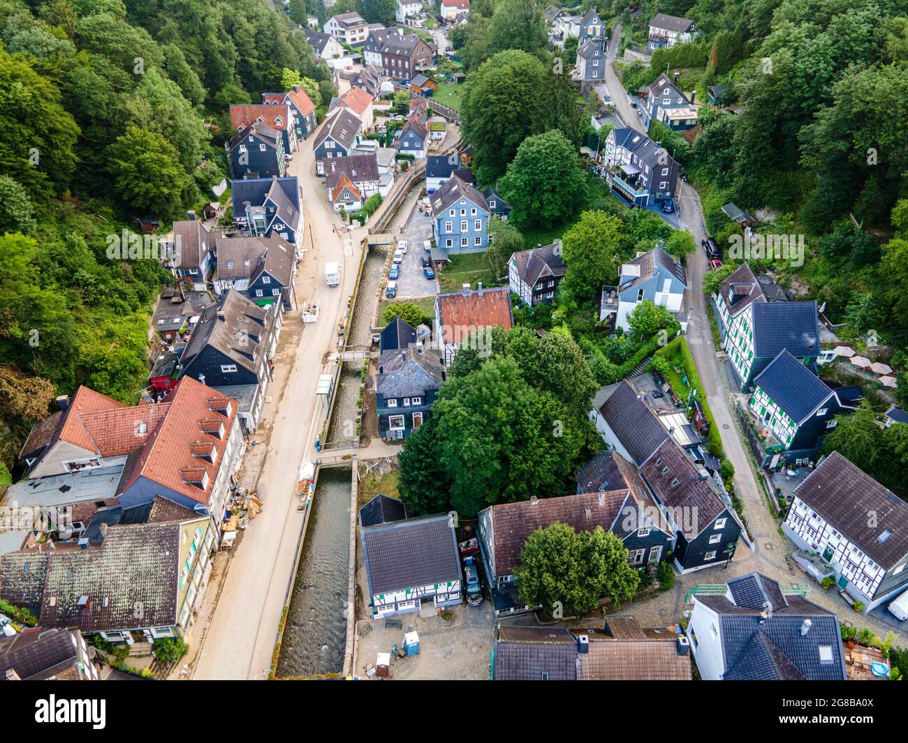 Solingen Unterburg, Germany. 19th July, 2021. View of the devastated town centre with Eschbachstraße. The village remains completely closed until further notice, the residents have been evacuated. During the flood, Eschbach and Wupper overflowed their banks, Eschbachstraße was completely flooded. (Aerial photo with a drone) Credit: David Inderlied/dpa/Alamy Live News Stock Photo