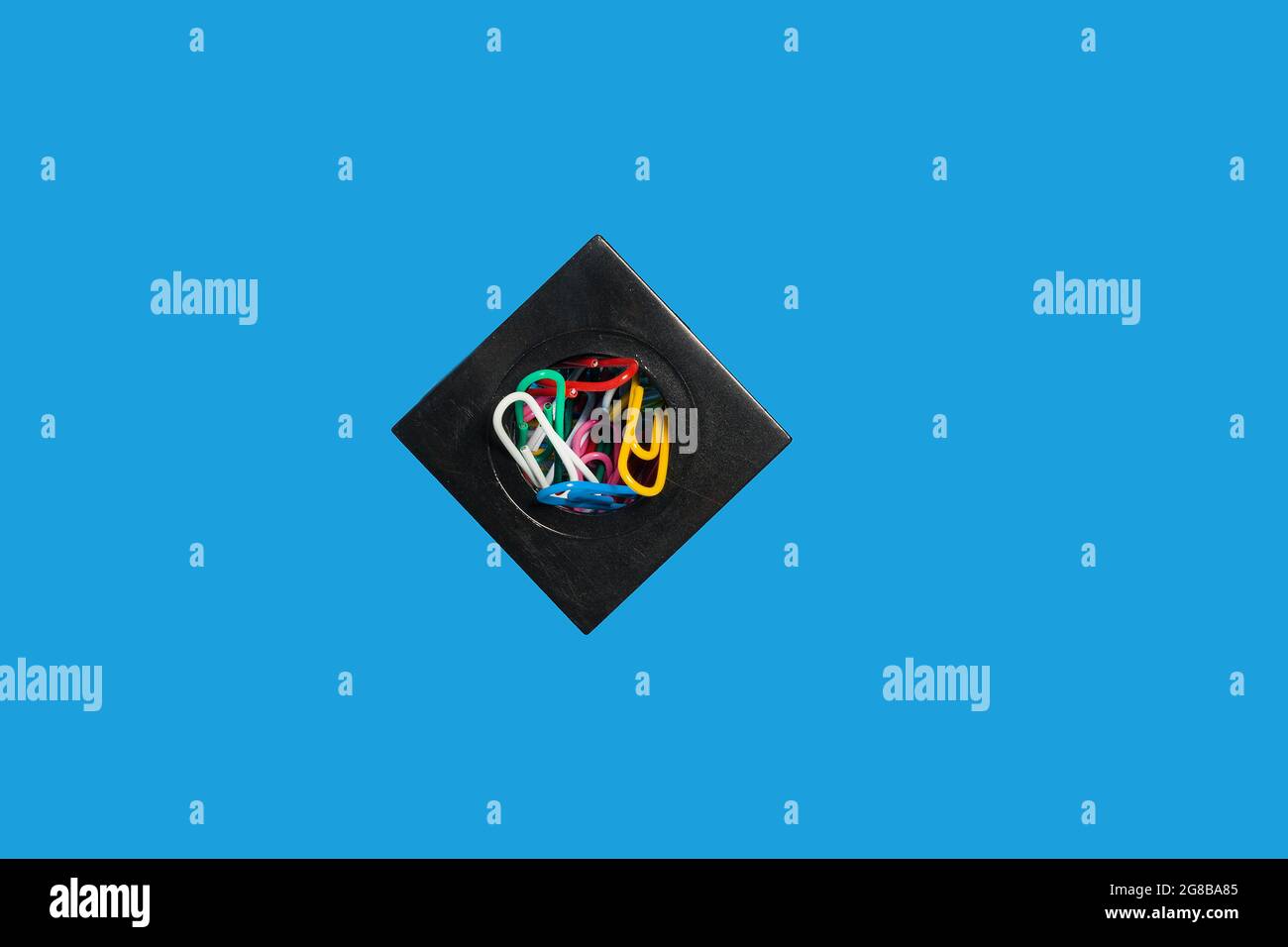 colorful paper clips in a container, school accessories Stock Photo