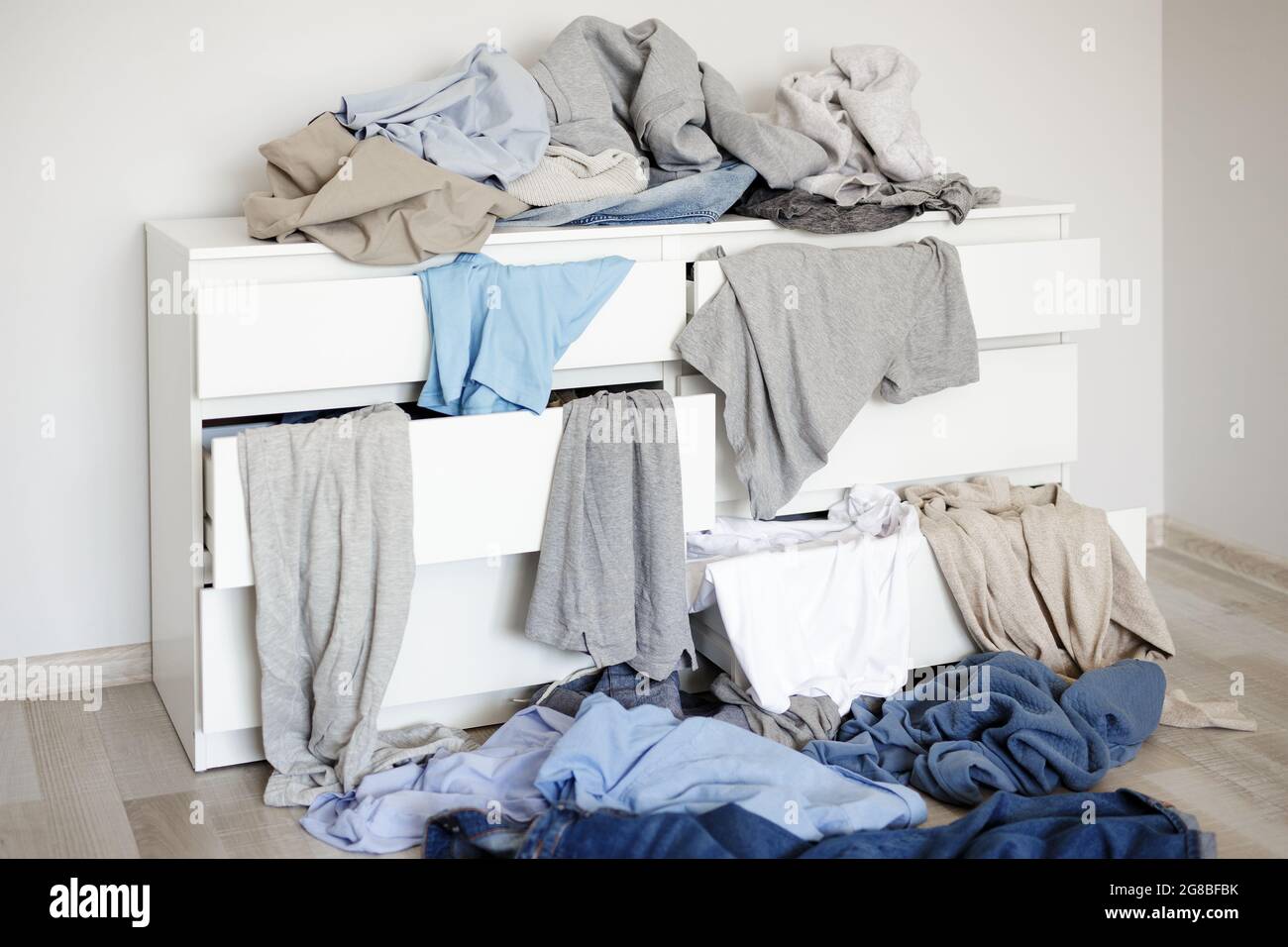 pile of colorful dirty laundry on the chest of drawers Stock Photo Alamy