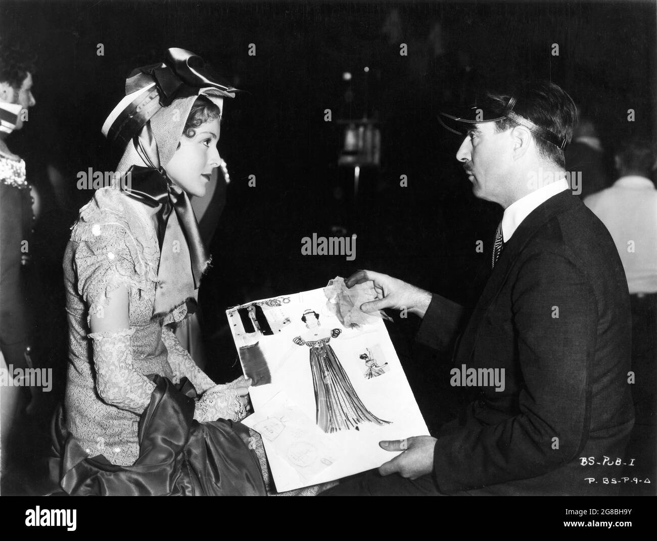 FRANCES DEE and Costume Designer and Production Designer ROBERT EDMOND JONES looking at one of his costume design drawings during filming of BECKY SHARP 1935 director ROUBEN MAMOULIAN novel Vanity Fair by William Makepeace Thackeray 1st Feature Film in 3 Strip Technicolor Cinematography Ray Rennahan Pioneer Pictures Corporation / RKO Radio Pictures Stock Photo