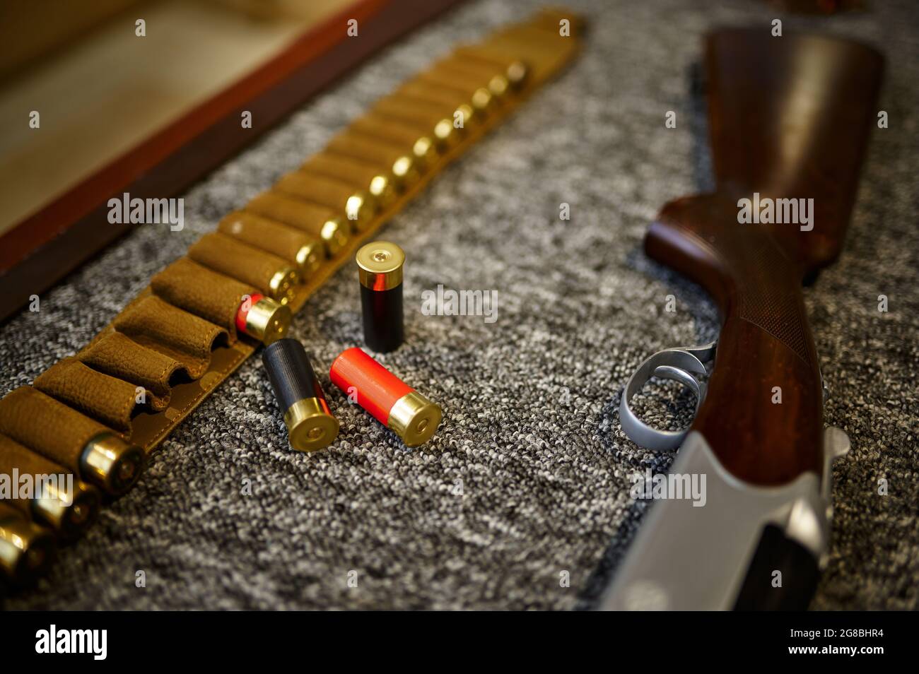 Hunting rifle, bandolier and cartridges, gun store Stock Photo Alamy
