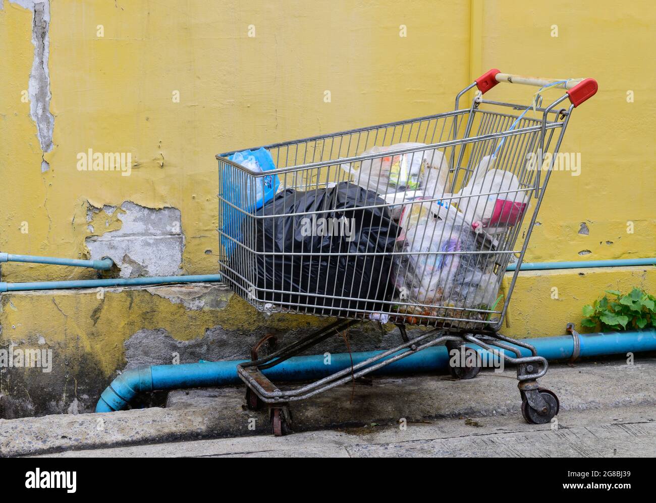 Shopping cart full of garbage bags on the streets Stock Photo Alamy