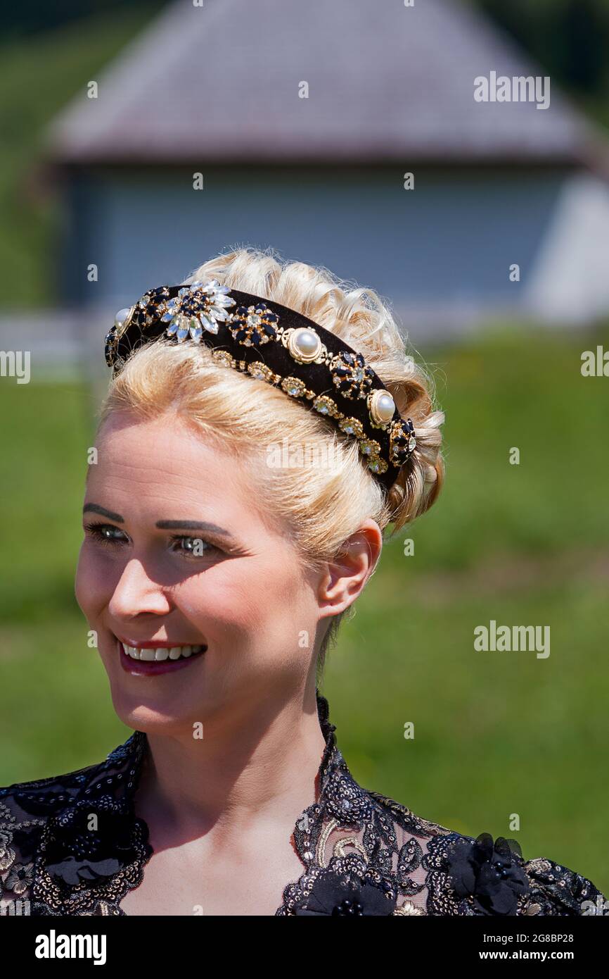 Portrait of blonde woman in lace dress with hairband and curly hair from front Stock Photo