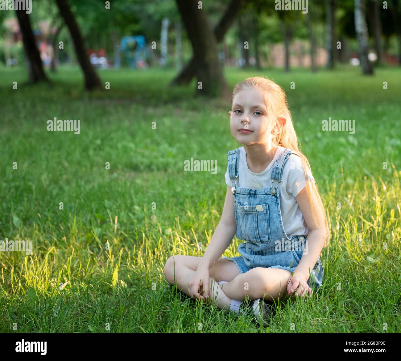 Sad girl sitting grass hi-res stock photography and images - Alamy