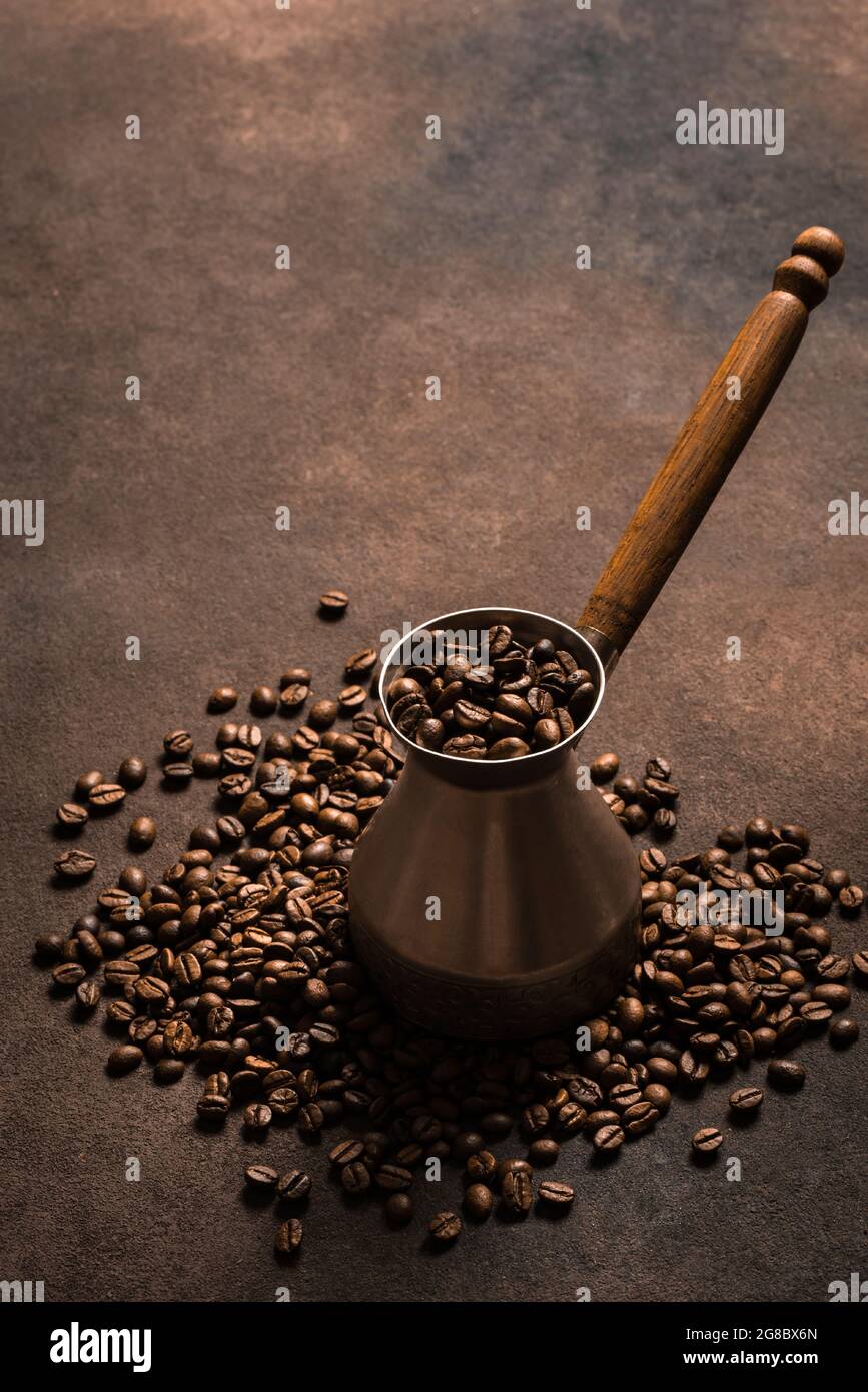 Roasted coffee beans and turk (cezve). Turkish coffee composition. Stock Photo