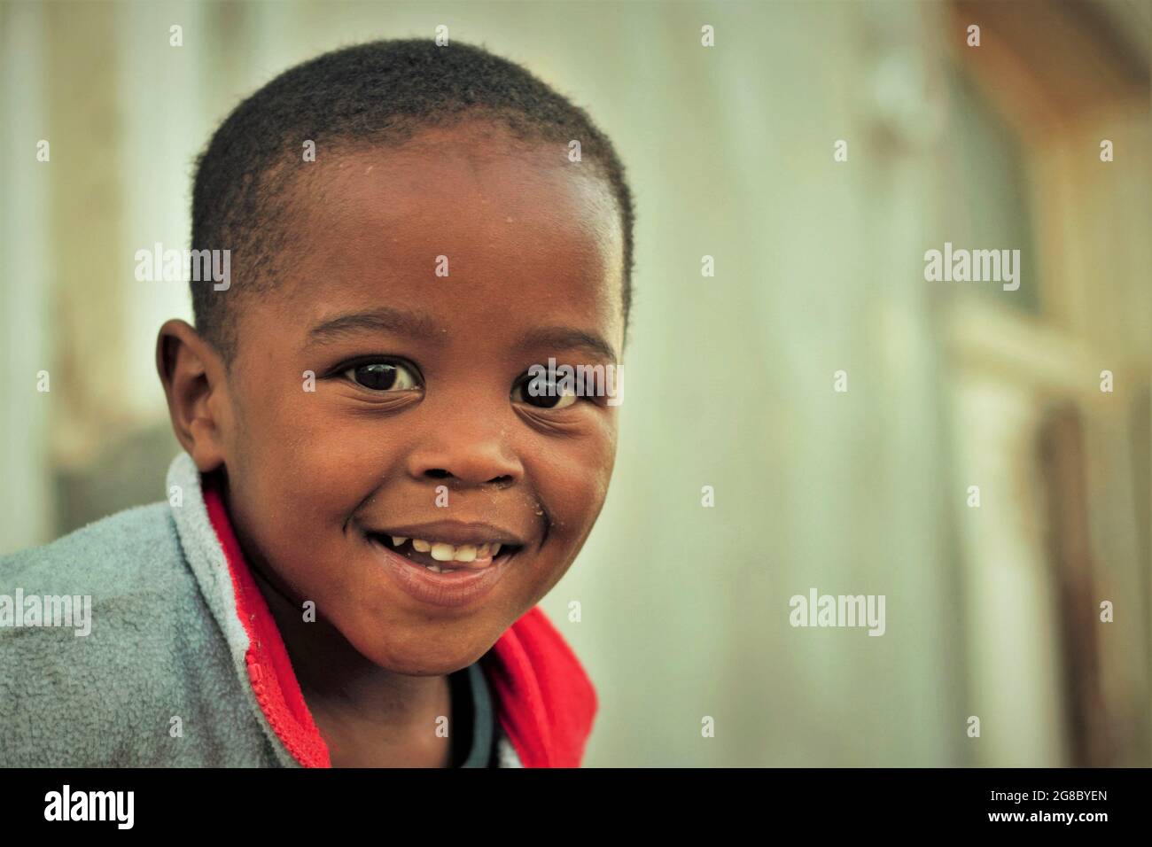 A young , black African boy's smiling face in the late afternoon Stock Photo Alamy