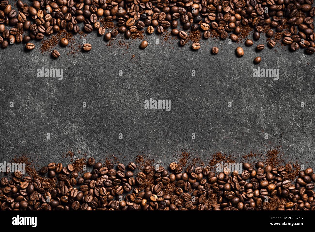Coffee beans and ground coffee on black background, top view, copy space. Roasted  coffee concept border. Stock Photo