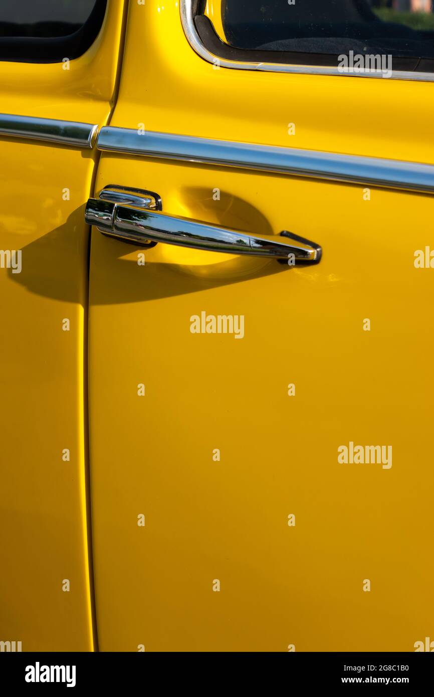 https://c8.alamy.com/comp/2G8C1B0/a-door-handle-on-a-yellow-restored-classic-car-photo-taken-in-natural-light-2G8C1B0.jpg