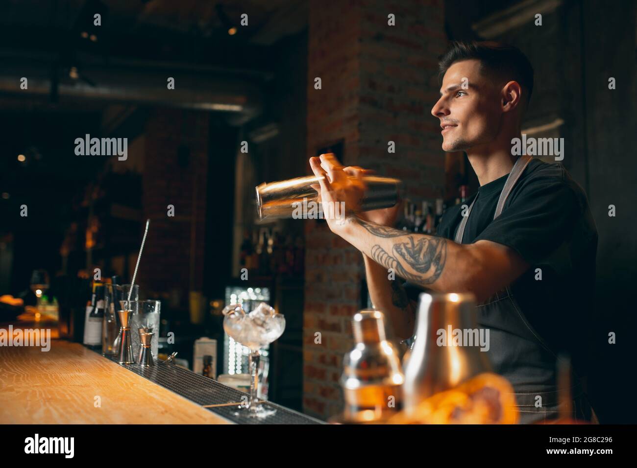 Shaking, mixing. One professional bartender shaking an alcohol drink in