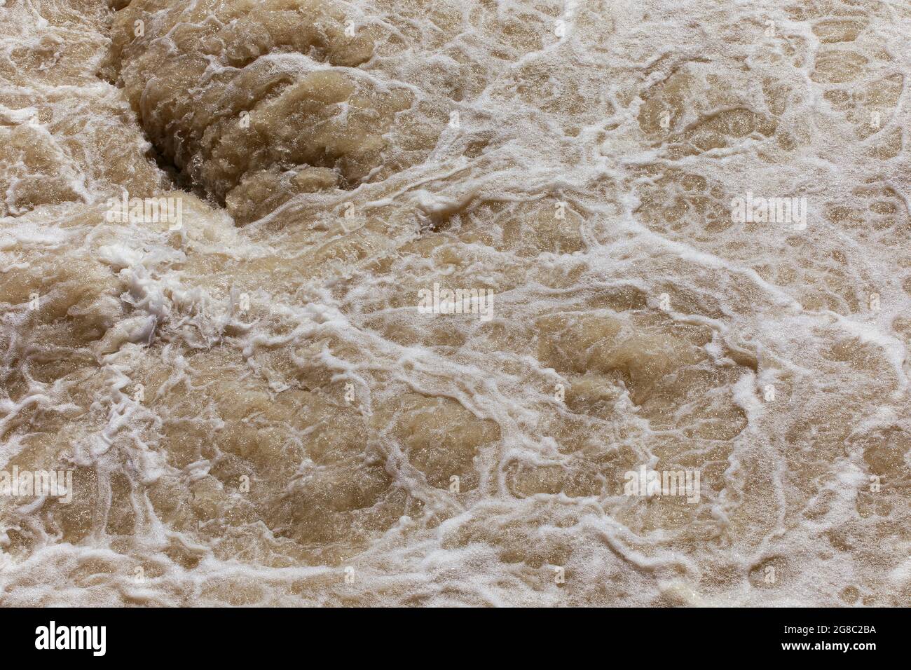 Water foam texture, rough water on the river, natural background, flood, power in nature concept. Stock Photo