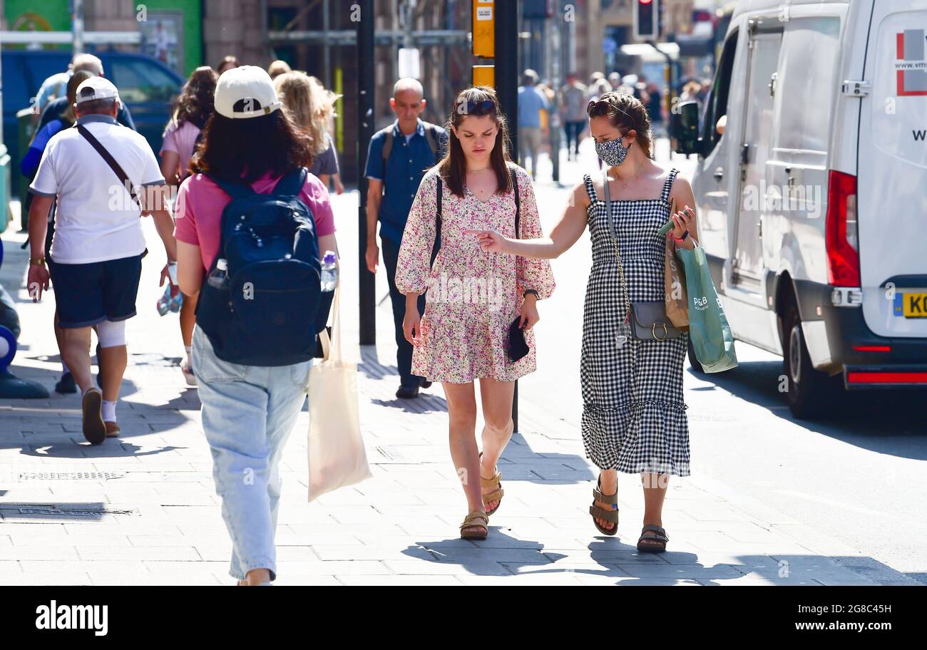Brighton UK 19th July 2021 - Shoppers some still wearing face coverings in Brighton as COVID-19 restrictions are lifted in England on what has become known as Freedom Day: Credit Simon Dack / Alamy Live News Stock Photo