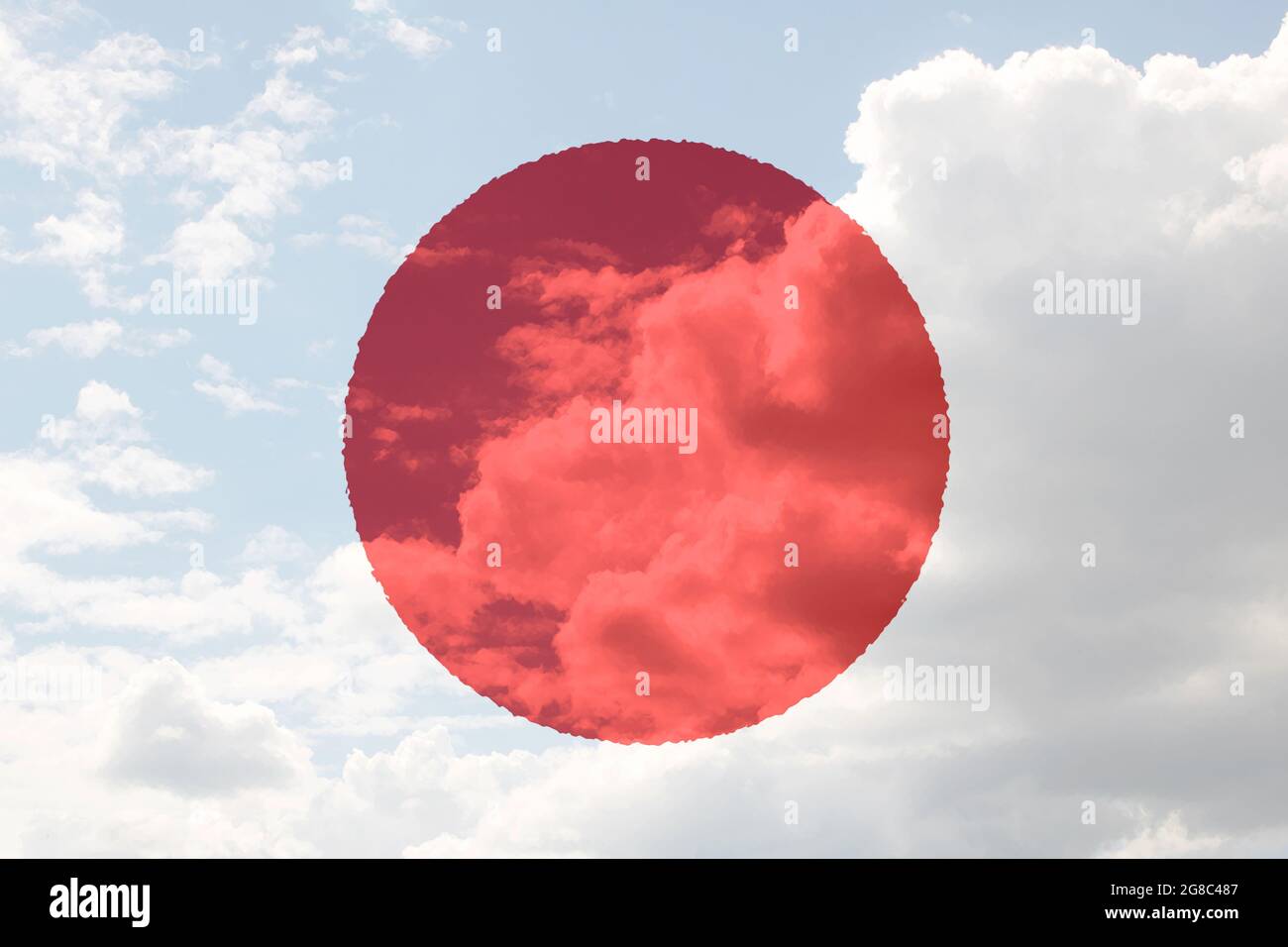 Japan flag in hand on blue sky with clouds close up Stock Photo - Alamy