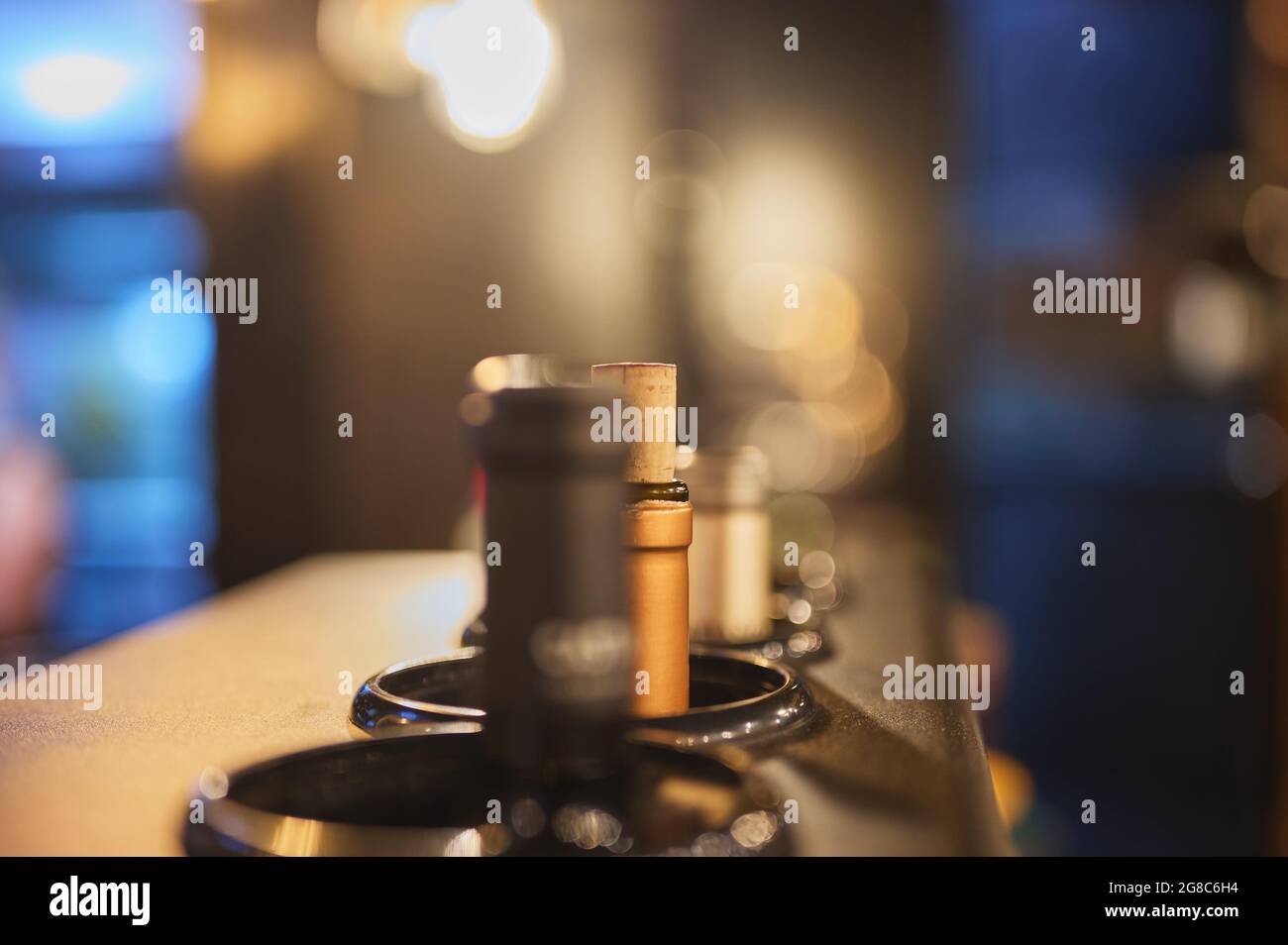 detail of wine bottles placed in a cooler at a restaurant Stock Photo
