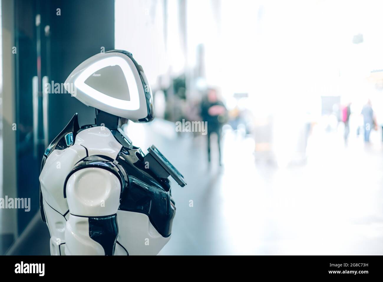 Technological progress of smart robot assistant with artificial intelligence in public place. Futuristic concept of robotics, machines in daily life Stock Photo