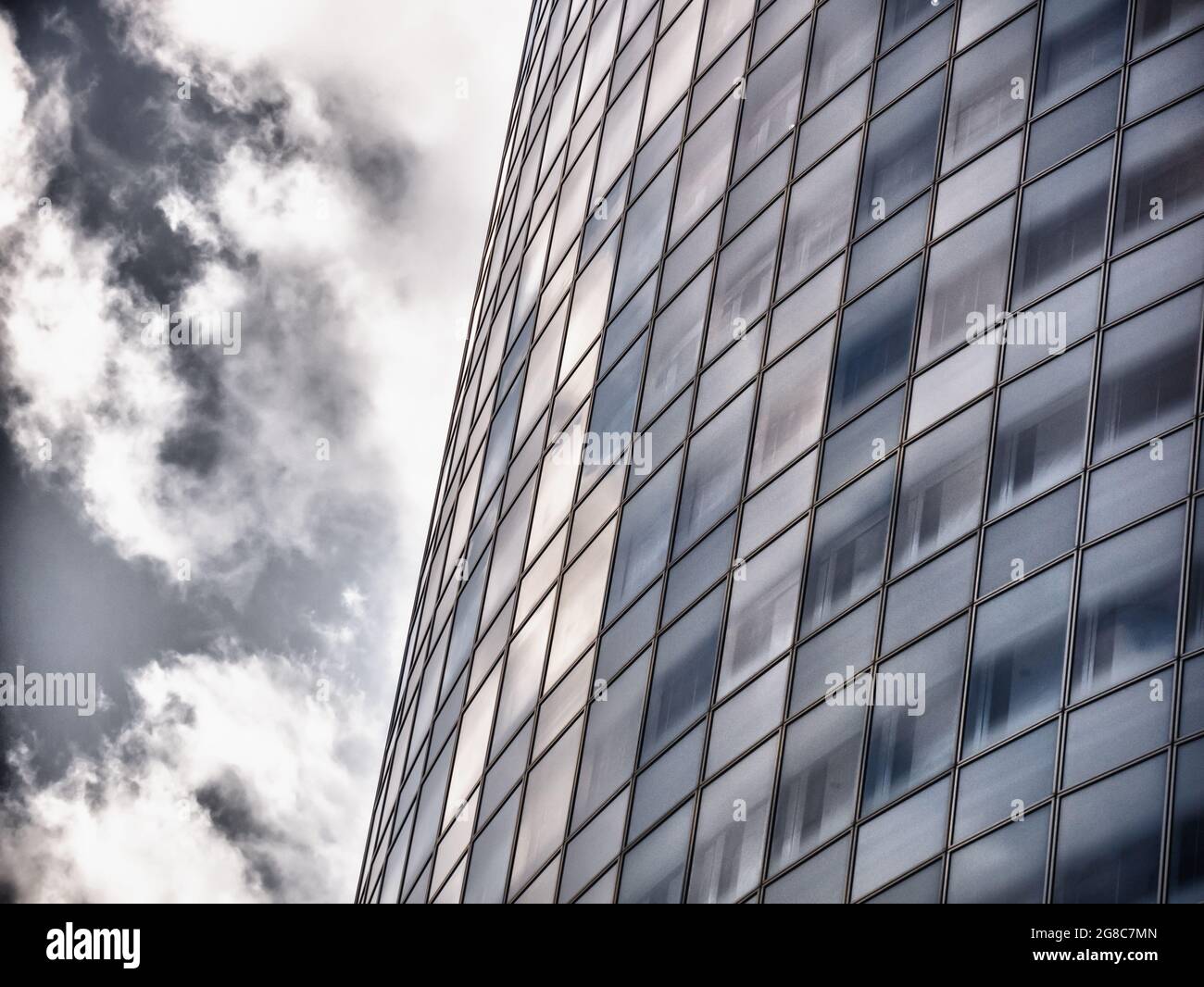 Low angle shot of a modern high-rise building under a cloudy sky Stock ...