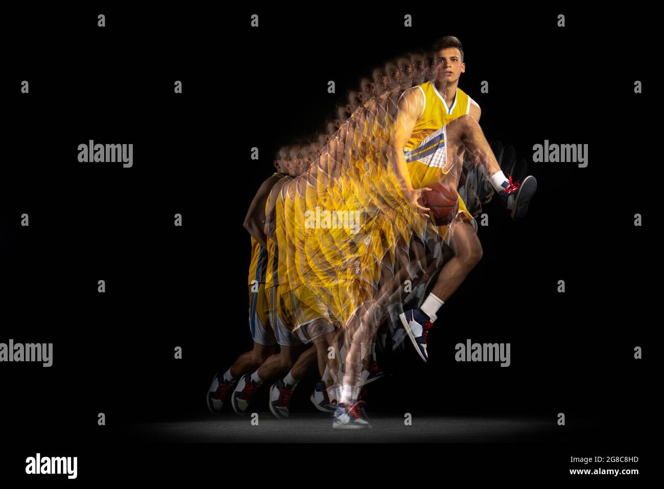 Young caucasian basketball player in motion and action isolated on dark ...