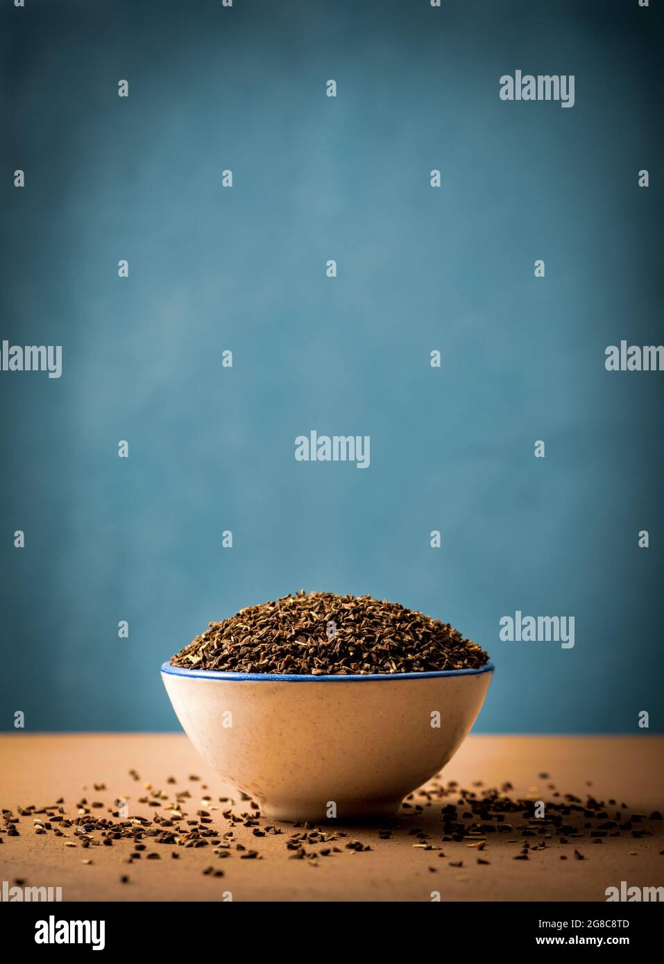 Vertical shot of peganum harmala seeds in a bowl Stock Photo