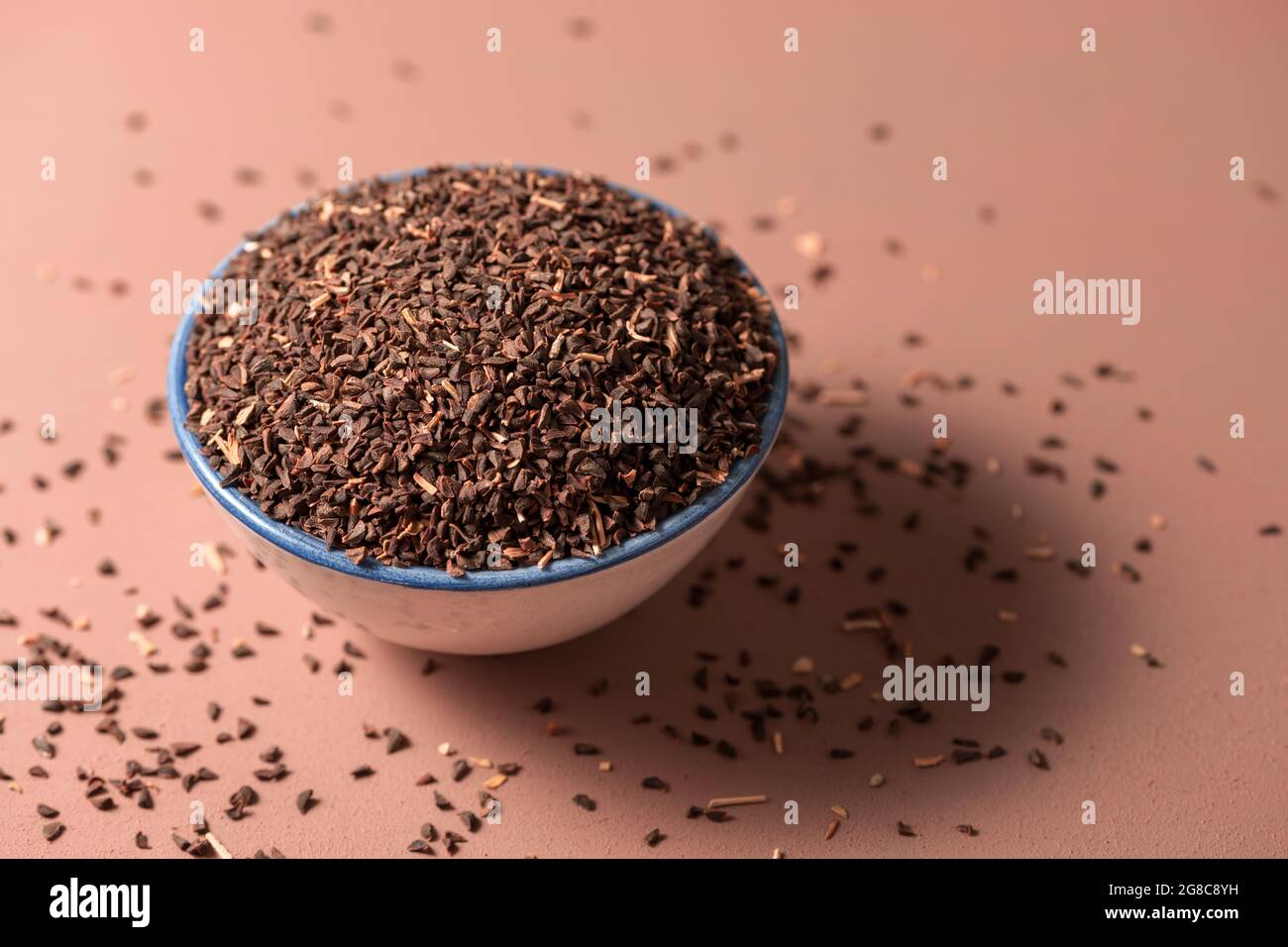 Closeup shot of peganum harmala seeds in a bowl Stock Photo