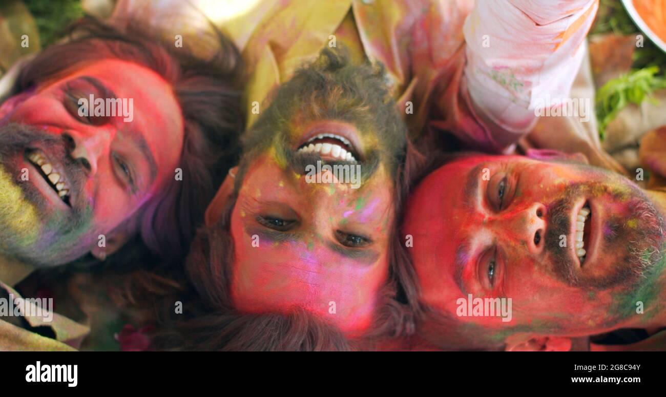 Top view of funny guys with painted faces celebrating the Holi festival  Stock Photo - Alamy