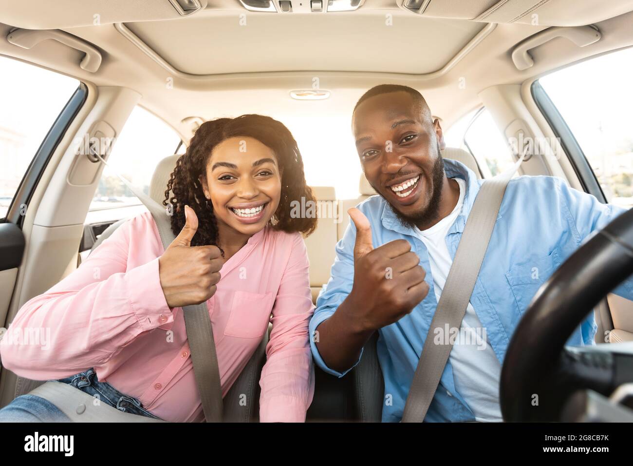 Thumbs up african woman sitting hi-res stock photography and images - Alamy