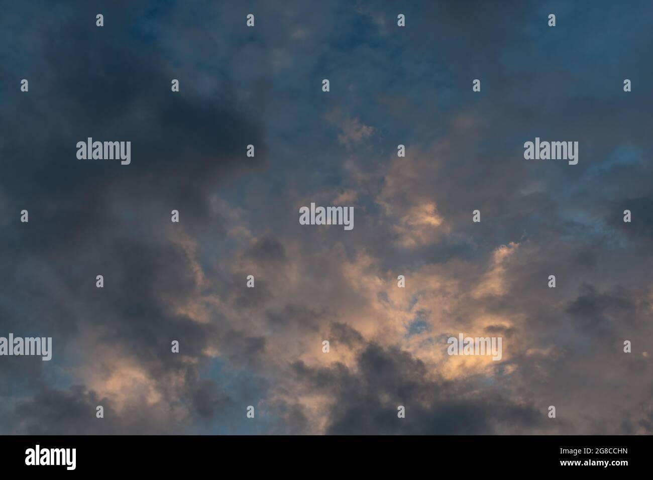 Dramatic grey, blue and apricot twilight sky. Stock Photo