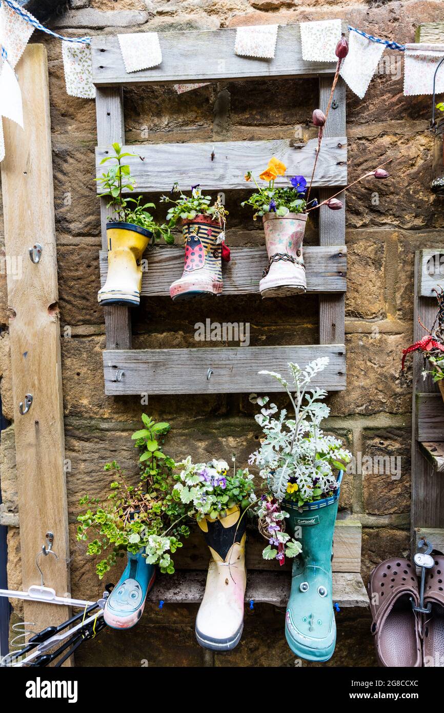 Creative planting,recycling,reusing,plants in boots,plant pots,unusual,planting,plants,flowers,planted,reuse,repair,recycling,recycled,flower pots, Stock Photo