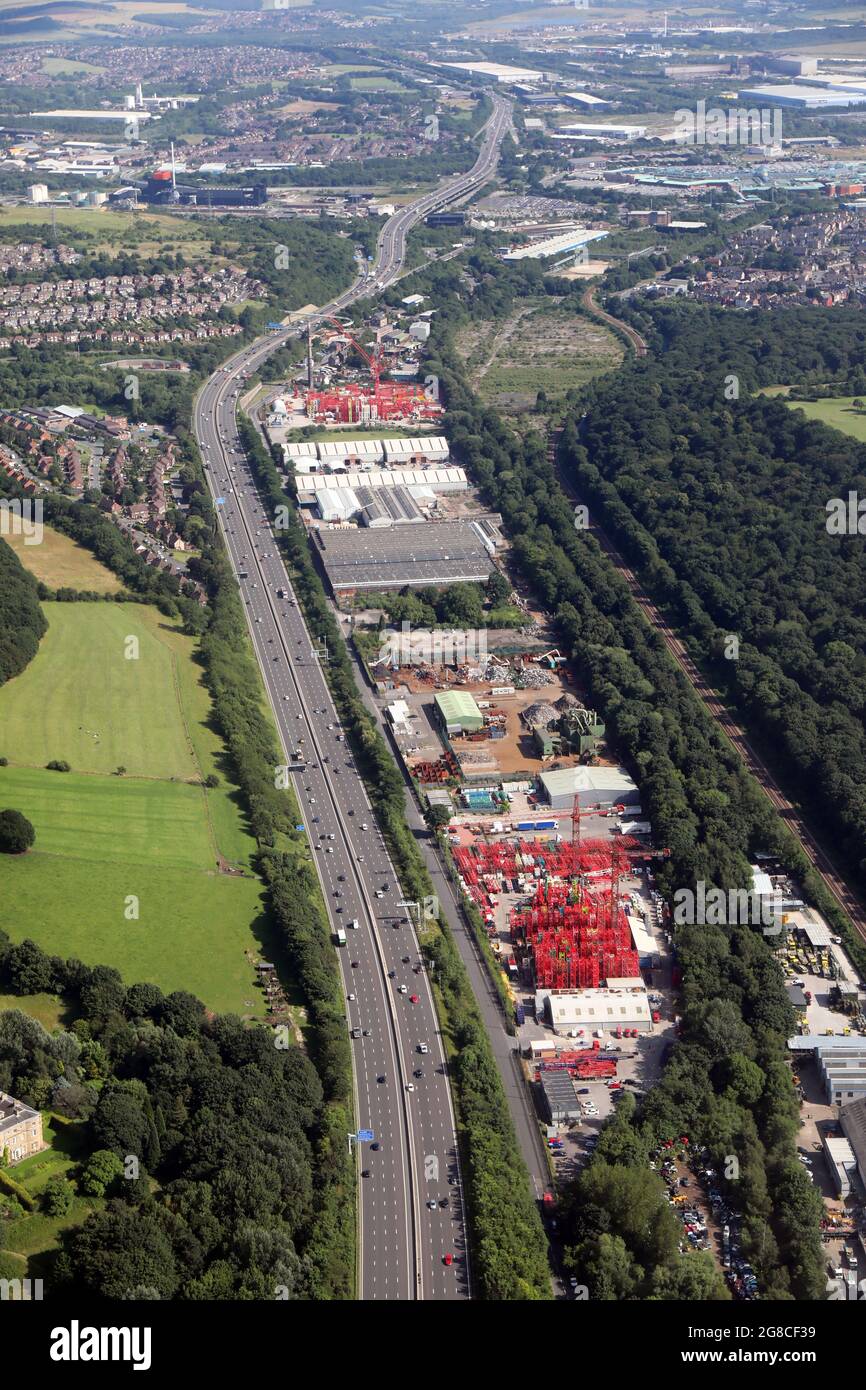 aerial view looking south down the M1 motorway near Sheffield of HTC Plant Limited's red cranes and plant hire, a landmark in the area Stock Photo