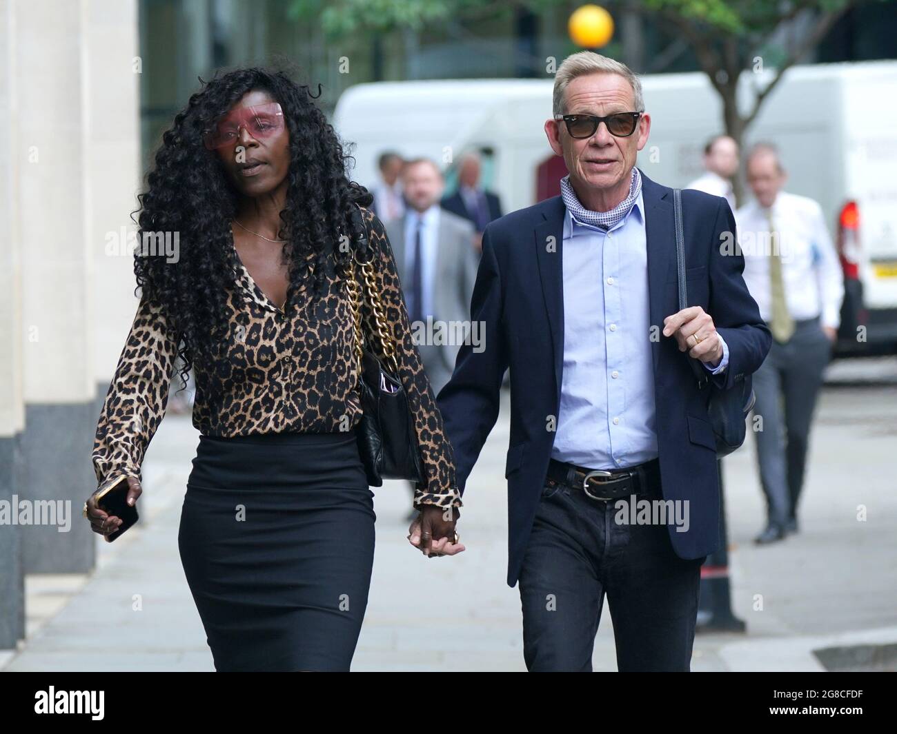 Paul Cook with his wife Jeni arriving at the Rolls Building at the Hight Court, London, for a hearing between two former Sex Pistols band members and the frontman over the pic