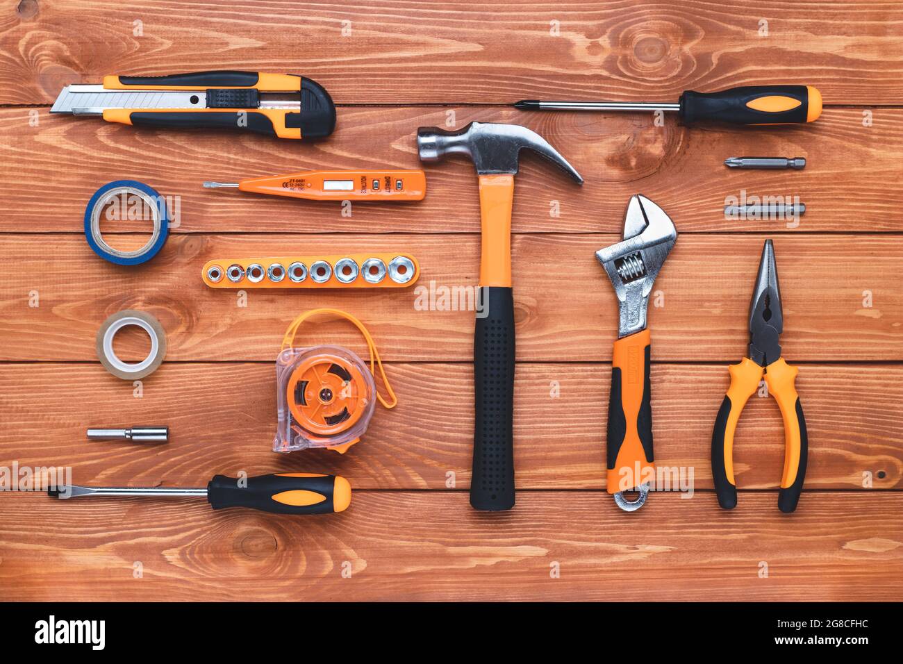 Set of construction tools on a wooden background. Hammer, wrench, pliers and screwdriver. Gift card for the holiday Labor Day, Father's Day. Equipment Stock Photo