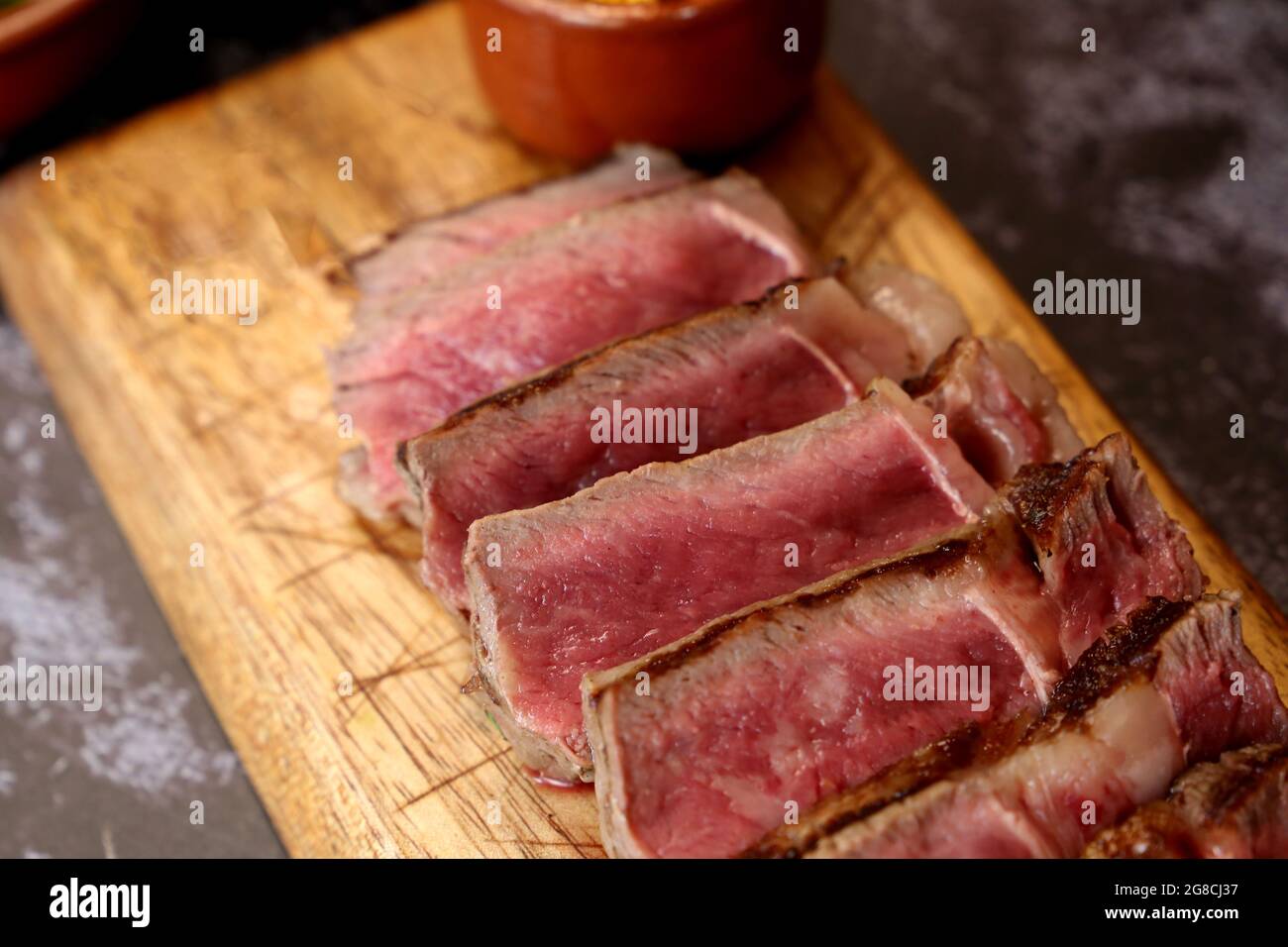 Short Rib or Costela Premium. Beautiful Steak sliced ​​on a wooden board. Rare Steak sliced. Stock Photo