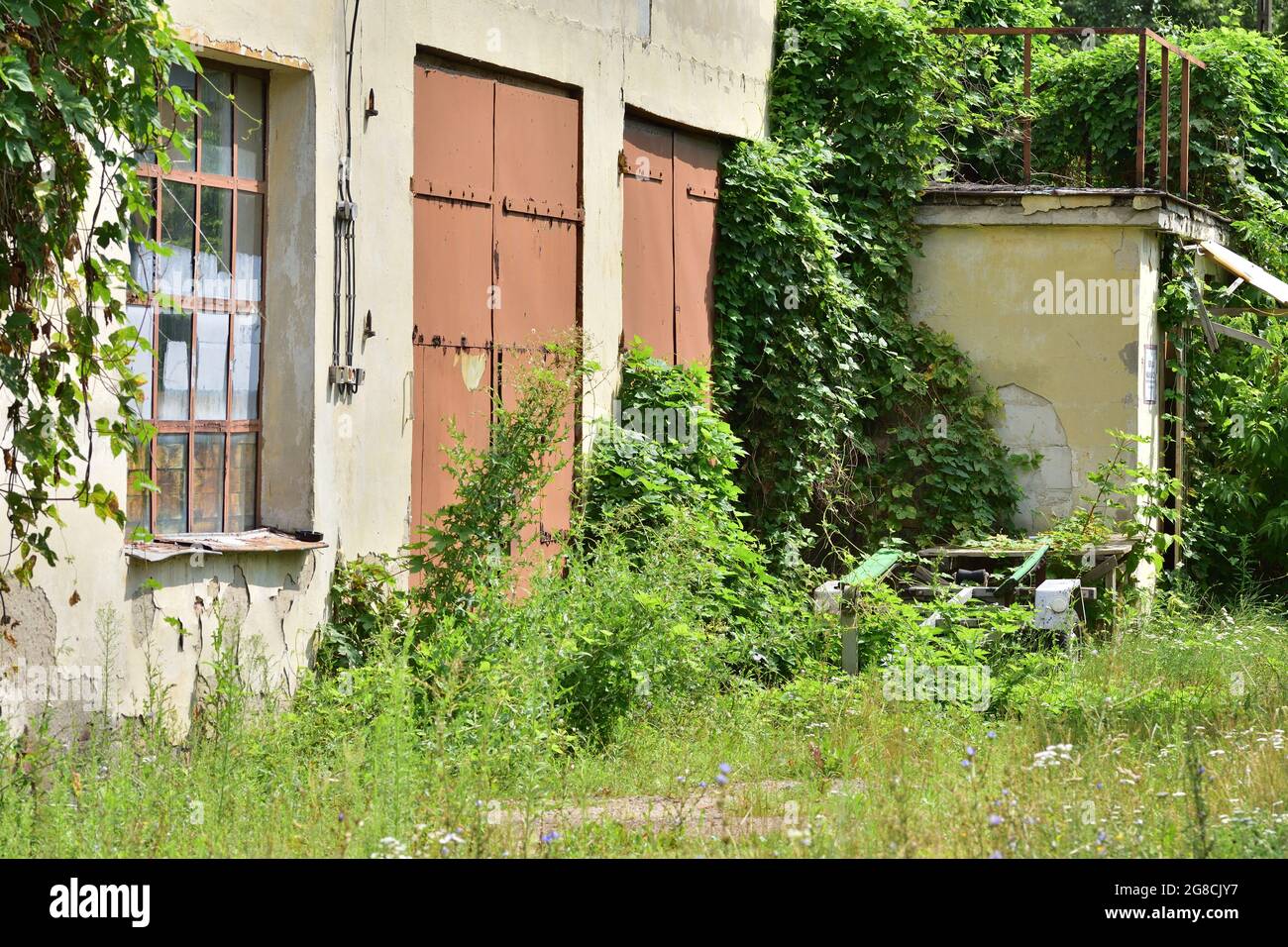 Abandoned and neglected building and garage. Summer. Stock Photo