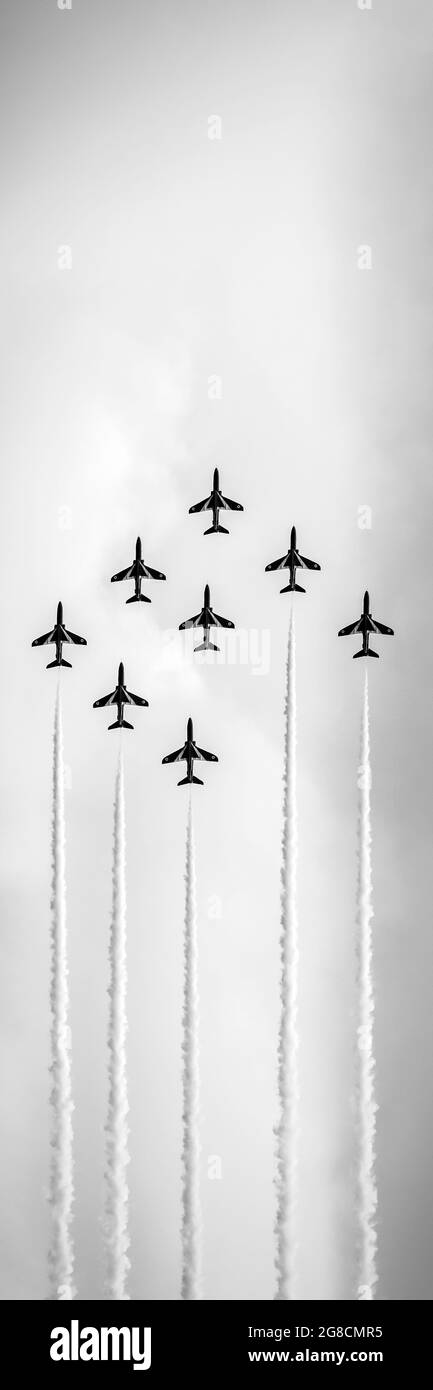 Black and white of red arrows display team flying on sky Stock Photo