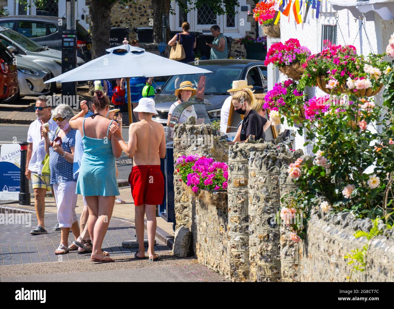 Beer, East Devon; 19th July 2021. UK Weather: Holidaymakers queue for icecream in glorious sunshine at the pretty fishing and seaside village of Beer, East Devon. Credit: Celia McMahon/Alamy Live News Stock Photo