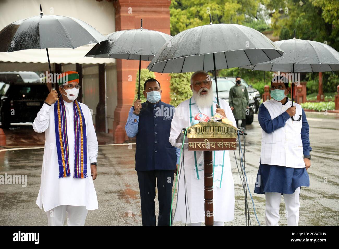 New Delhi, India. 19th July, 2021. Indian Prime Minister, Narendra Modi  holds an umbrella as he speaks to the media on the first day of the Monsoon  Session of Parliament 2021 at