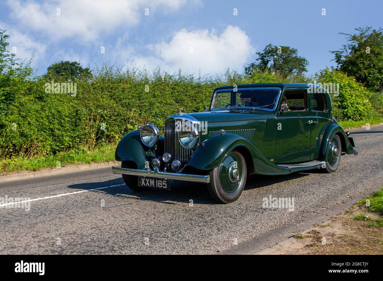 1936, 30s green British Bentley 4257cc 8 cyl petrol 2dr 3 speed automatic, sedan en-route to Capesthorne Hall classic July car show, Cheshire, UK Stock Photo