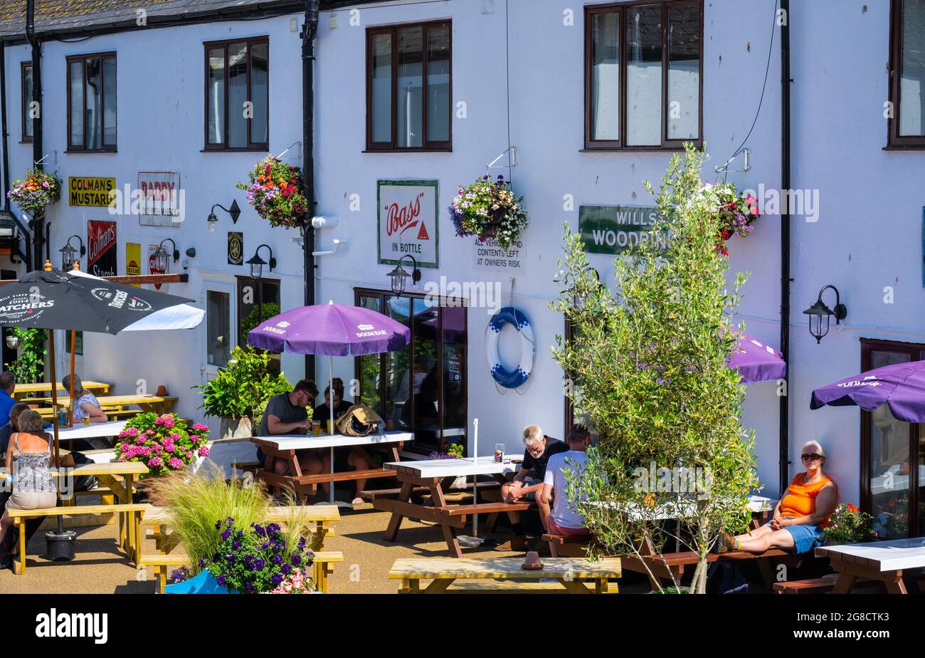 Beer, East Devon; 19th July 2021. UK Weather: Holidaymakers enjoy the glorious sunshine outside a pub at the pretty fishing and seaside village of Beer, East Devon on 'Freedom Day'. Credit: Celia McMahon/Alamy Live News Stock Photo