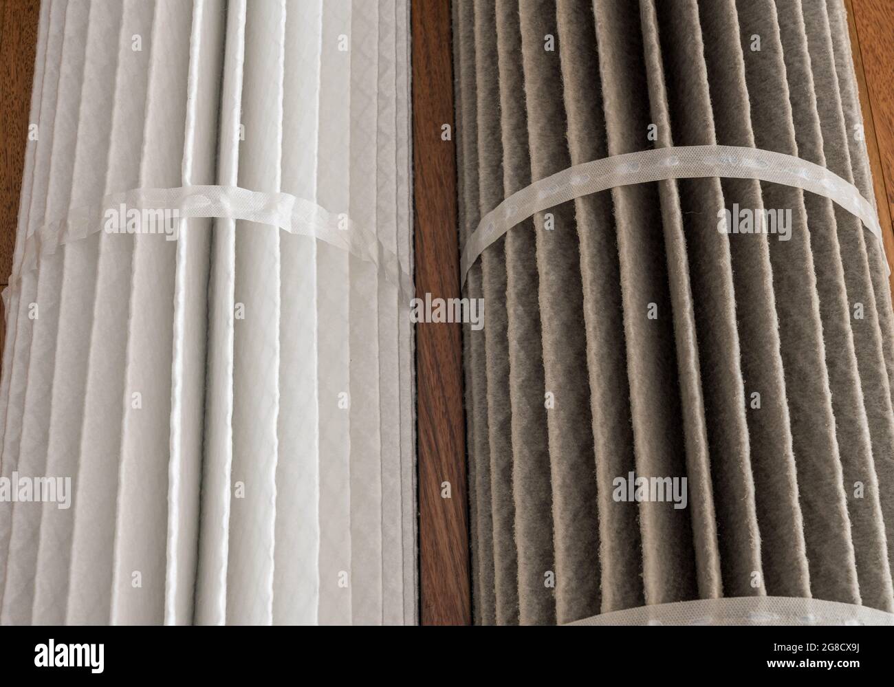 Close view of two HVAC air filters to show the difference between a