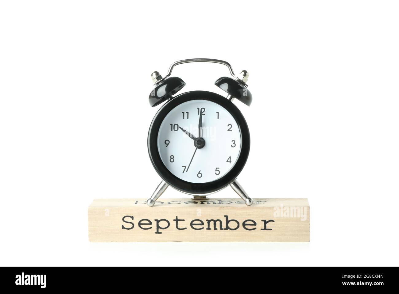 Alarm clock and wooden block with text September isolated on white ...