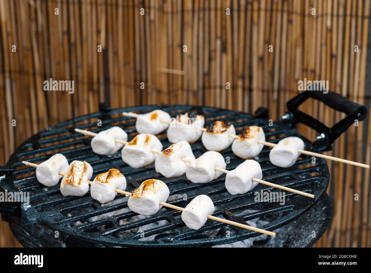 grilled skewers of marshmallow as dessert Stock Photo Alamy