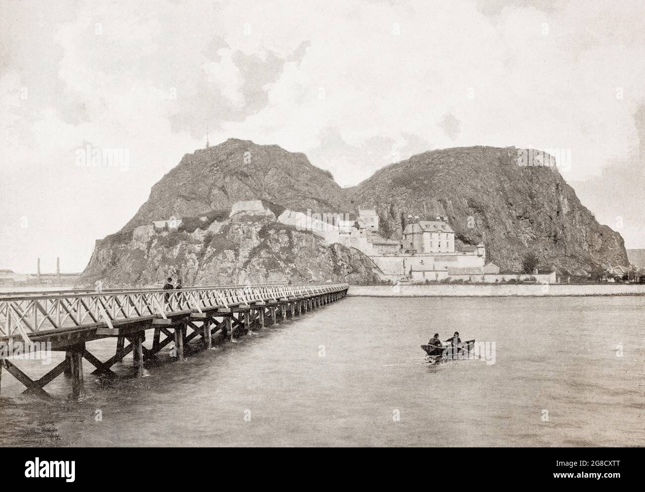 A late 19th century view of Dumbarton Castle, supposedly visited by Merlin, which has the longest recorded history of any stronghold in Scotland. It overlooks the Scottish town of Dumbarton, and sits on a plug of volcanic basalt known as Dumbarton Rock. Alexander II of Scotland built the medieval castle around 1220 in the ancient centre of the Kingdom of Strathclyde as a defence against the threat from Norway, whose kings ruled the Hebrides and the islands in the Clyde. It sheltered David II (in 1333–4) and Mary Queen of Scots (in 1548) until ships could take them to France and safety. Stock Photo