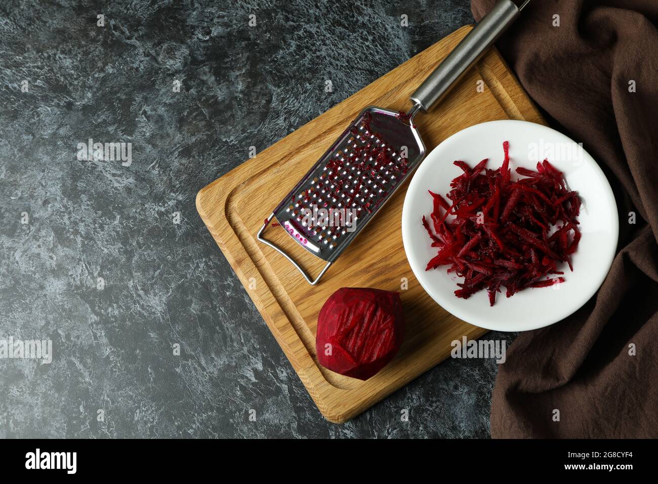 Fresh grated beets on black smokey table Stock Photo
