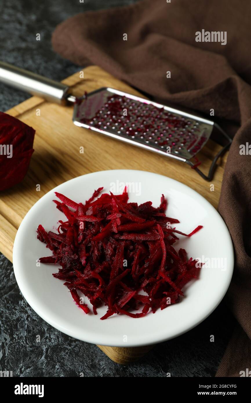 Fresh grated beets on black smokey table Stock Photo