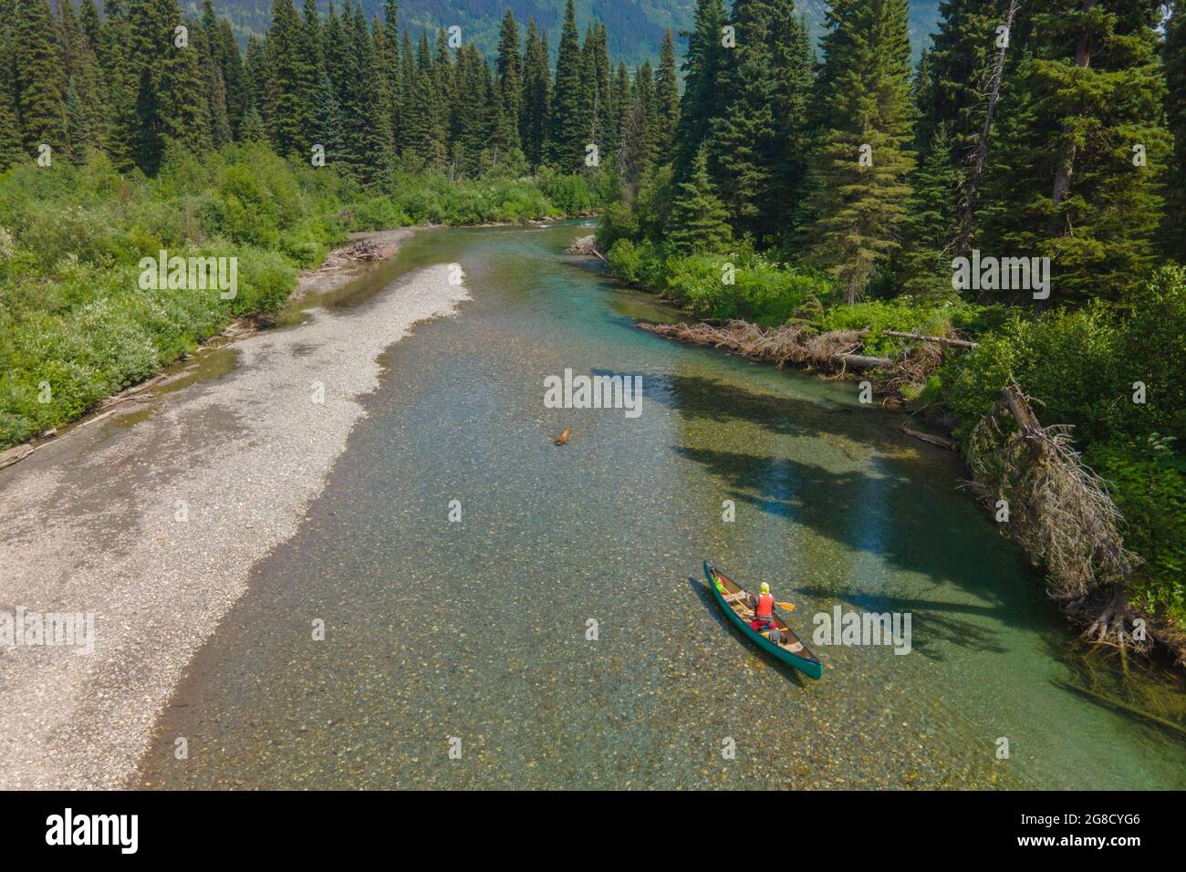 Solo canoeing in the headwaters of the Peace River, in British Columbia. Stock Photo